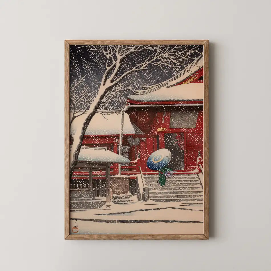 A framed painting of a traditional red building surrounded by snow and bare trees, with a person holding a blue umbrella walking up the stairs.