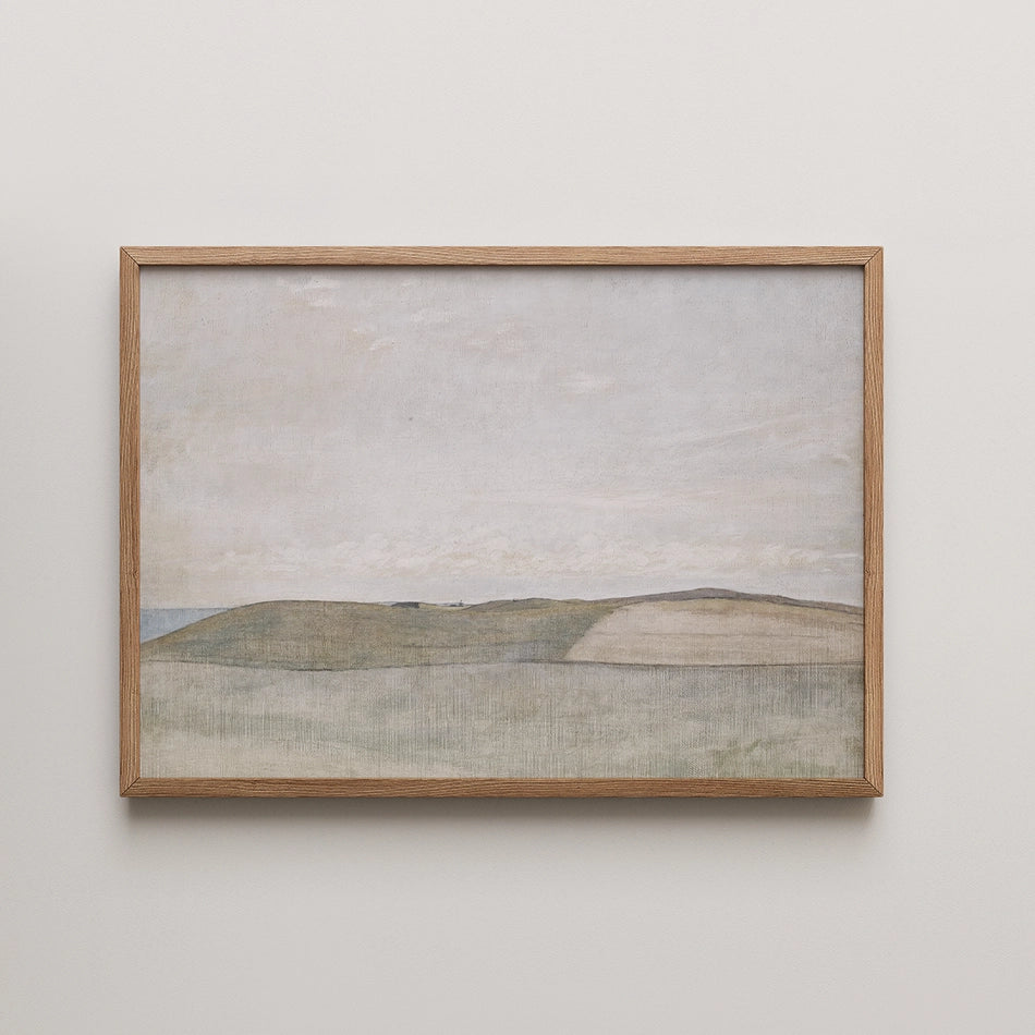 Framed painting of a serene landscape with rolling hills under a cloudy sky.