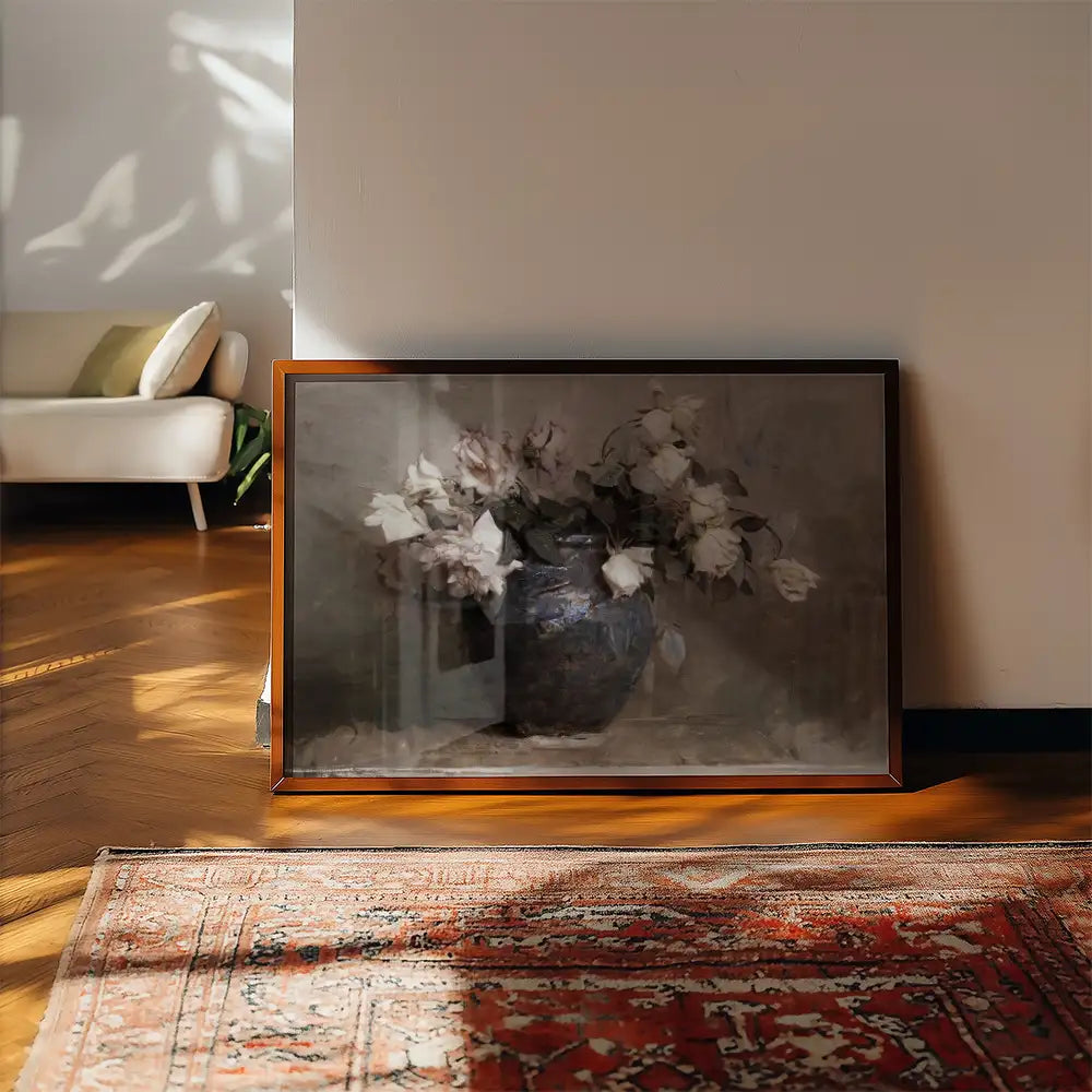 Framed painting of a vase filled with white flowers, displayed against a light wall in a cozy interior setting.