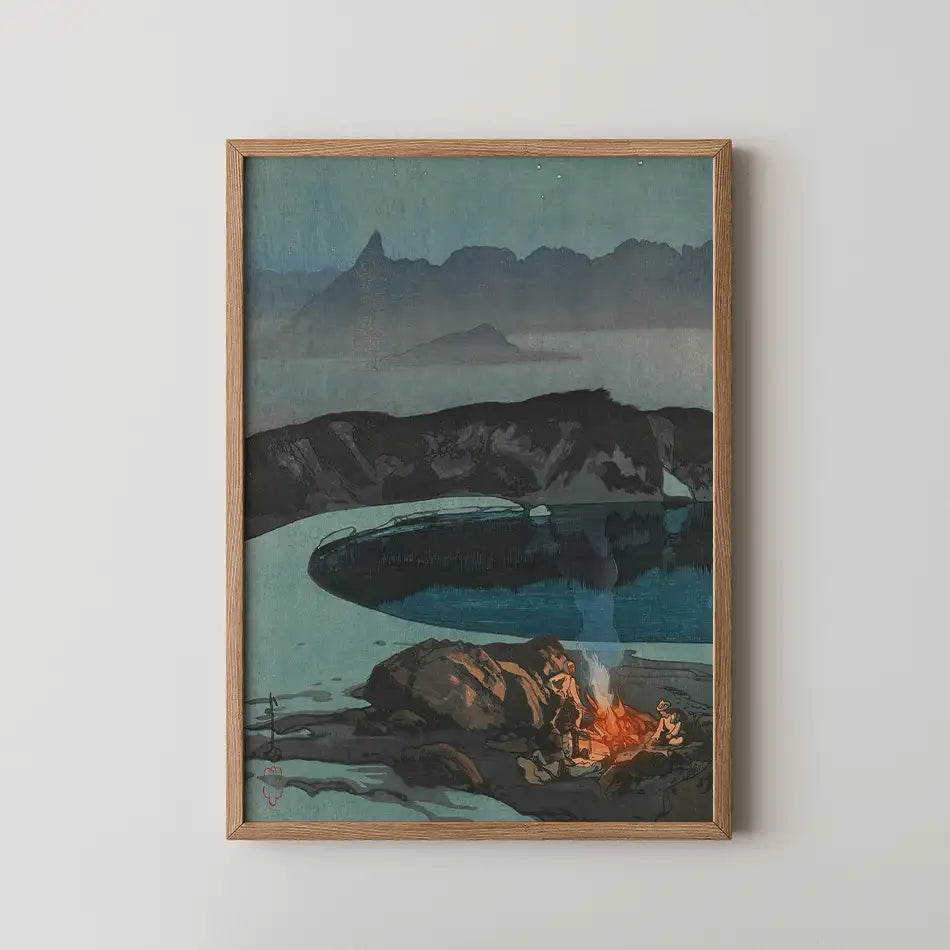 Framed painting of a serene landscape featuring a campfire by a body of water, surrounded by dark mountains and a twilight sky.