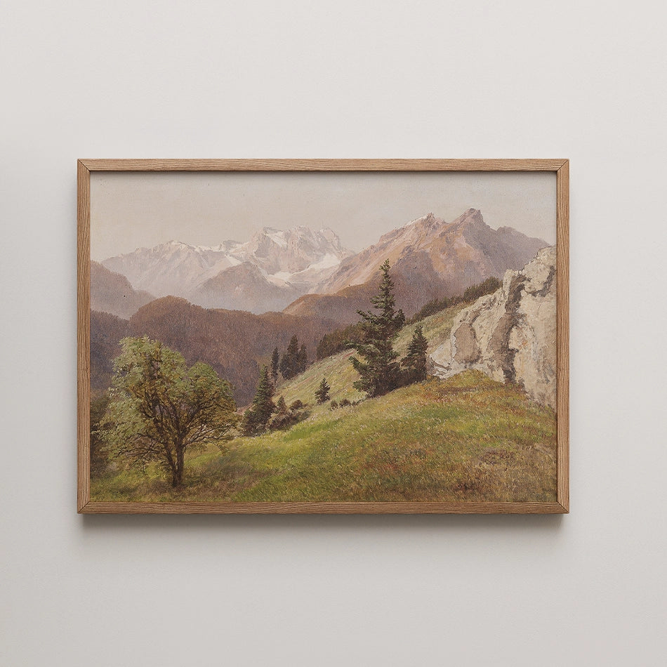 Framed painting of a mountainous landscape with greenery and trees in the foreground.