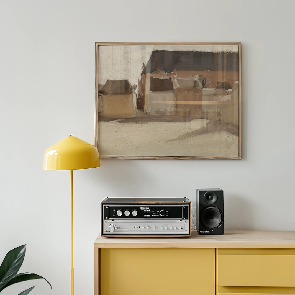 Framed abstract painting in neutral tones above a stylish yellow lamp and a vintage audio system on a wooden cabinet.