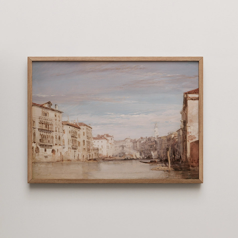 Painting of a serene canal scene in Venice, featuring historic buildings and a clear sky, framed in light wood.
