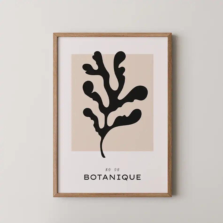Elegant abstract botanical art print featuring a black seaweed silhouette against a soft beige background, framed by a minimalist white border with bold typography reading 'BOTANIQUE.'