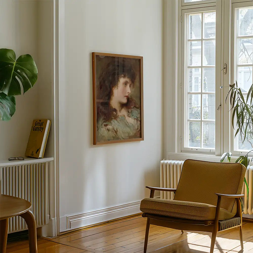Portrait painting framed and displayed on a wall in a bright room with a chair and potted plant.