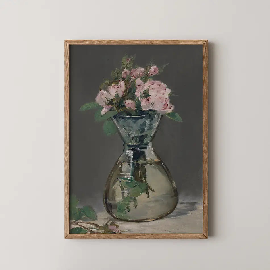 Painting of a vase with pink roses set against a dark background, framed in wooden decor.