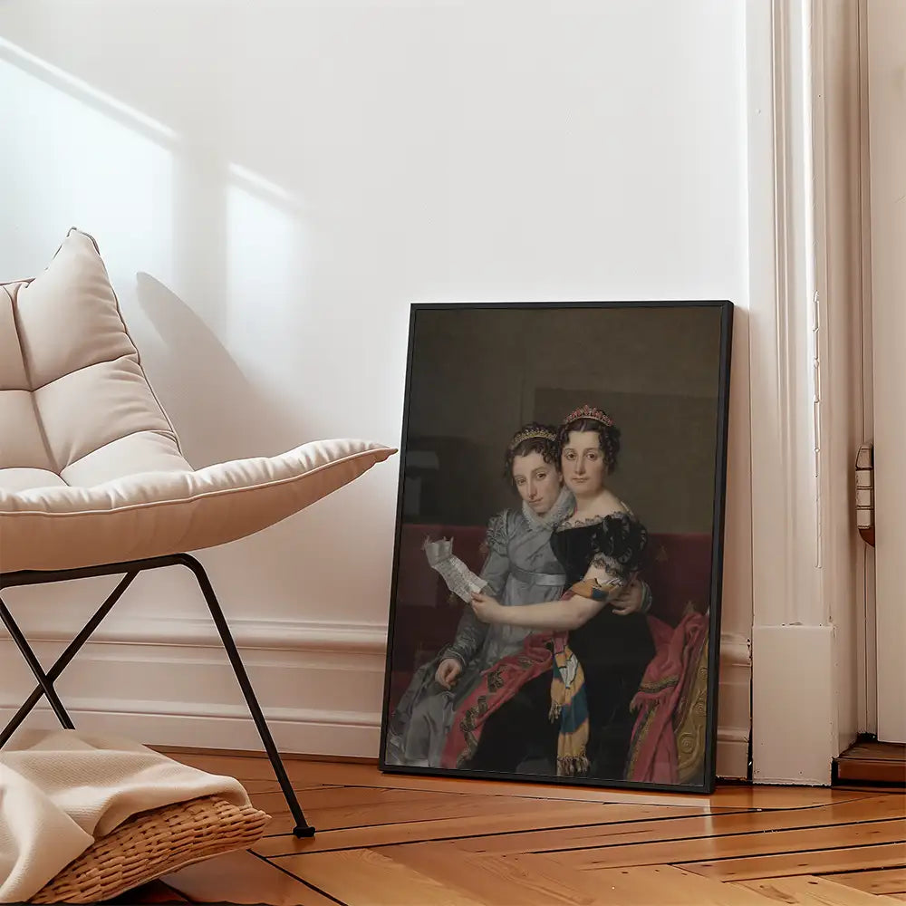 Framed painting of two women in elegant attire sitting together, displayed on a wooden floor beside a modern chair.