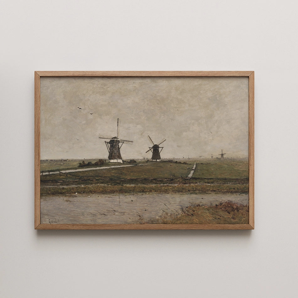 Painting of two windmills in a landscape with a cloudy sky and a waterway in the foreground, framed in natural wood.