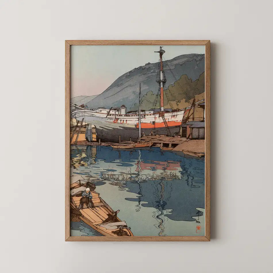Framed painting of a serene harbor scene featuring a large ship and small boats, with mountainous background and reflections on the water.