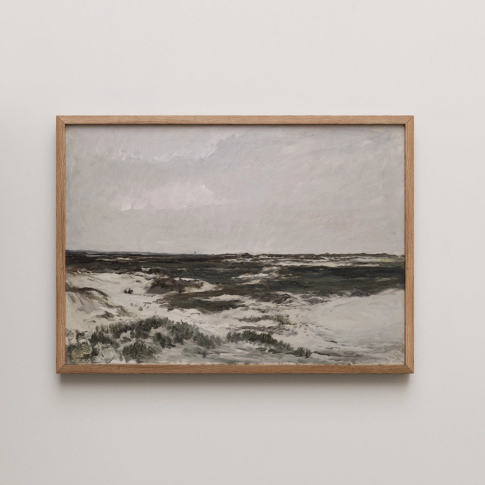 Framed painting depicting a cloudy seascape with sandy shores and green grass in the foreground.