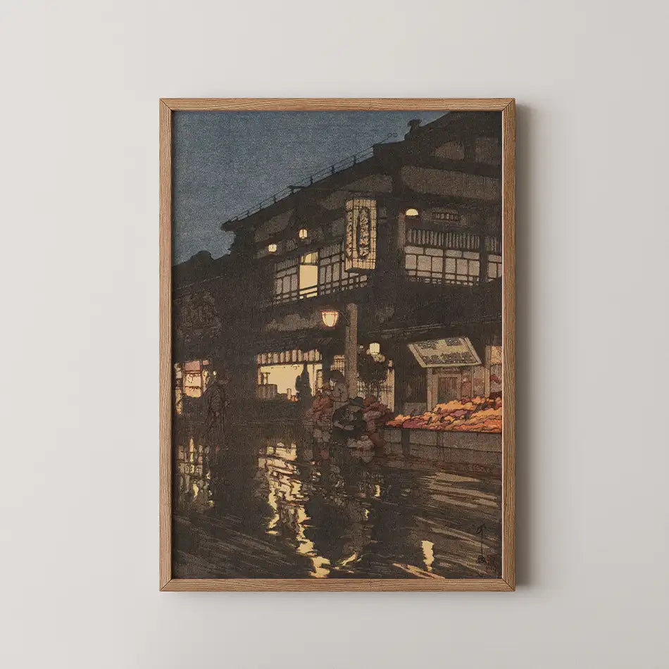 Framed painting of a nighttime urban scene with reflections in water, featuring traditional architecture and figures near a market.
