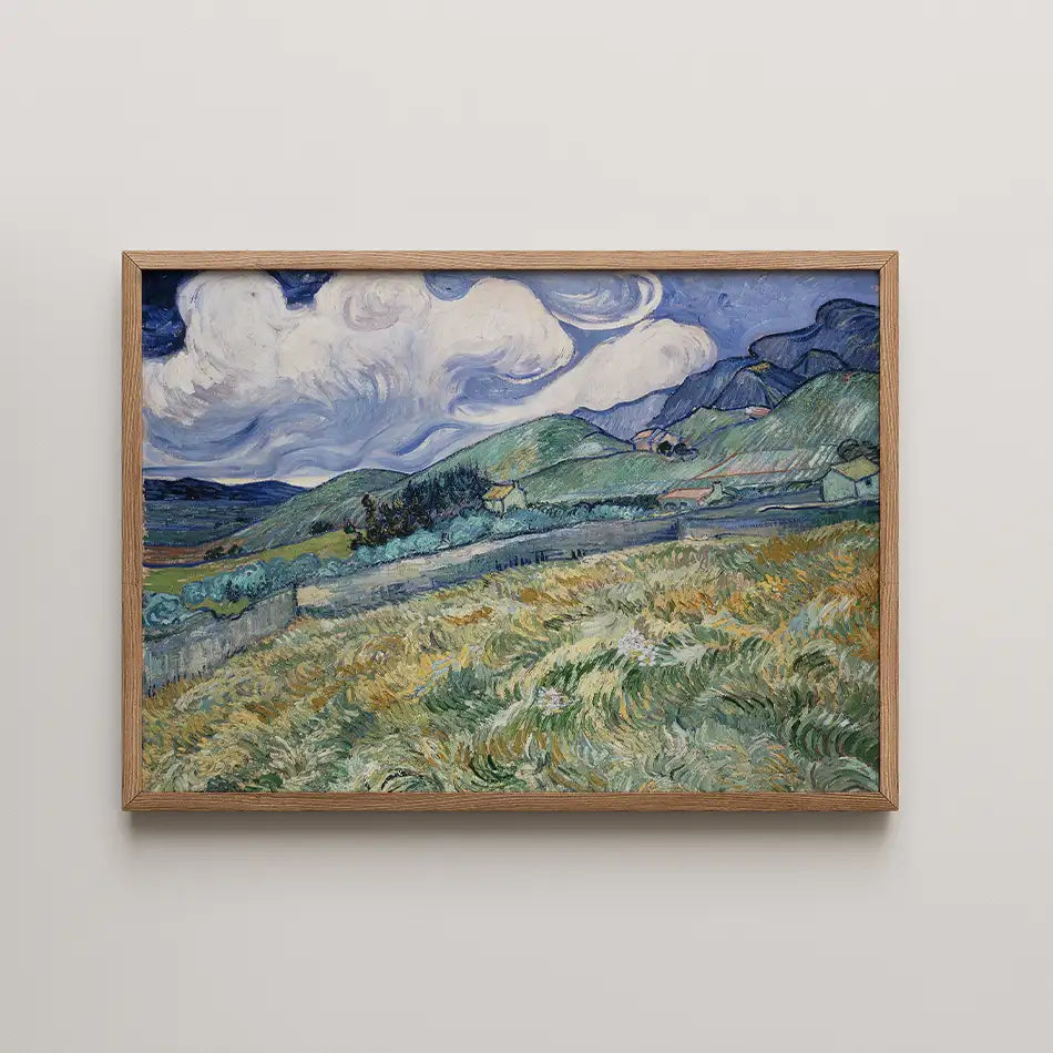 Framed painting of a vibrant landscape with rolling hills and dramatic clouds.
