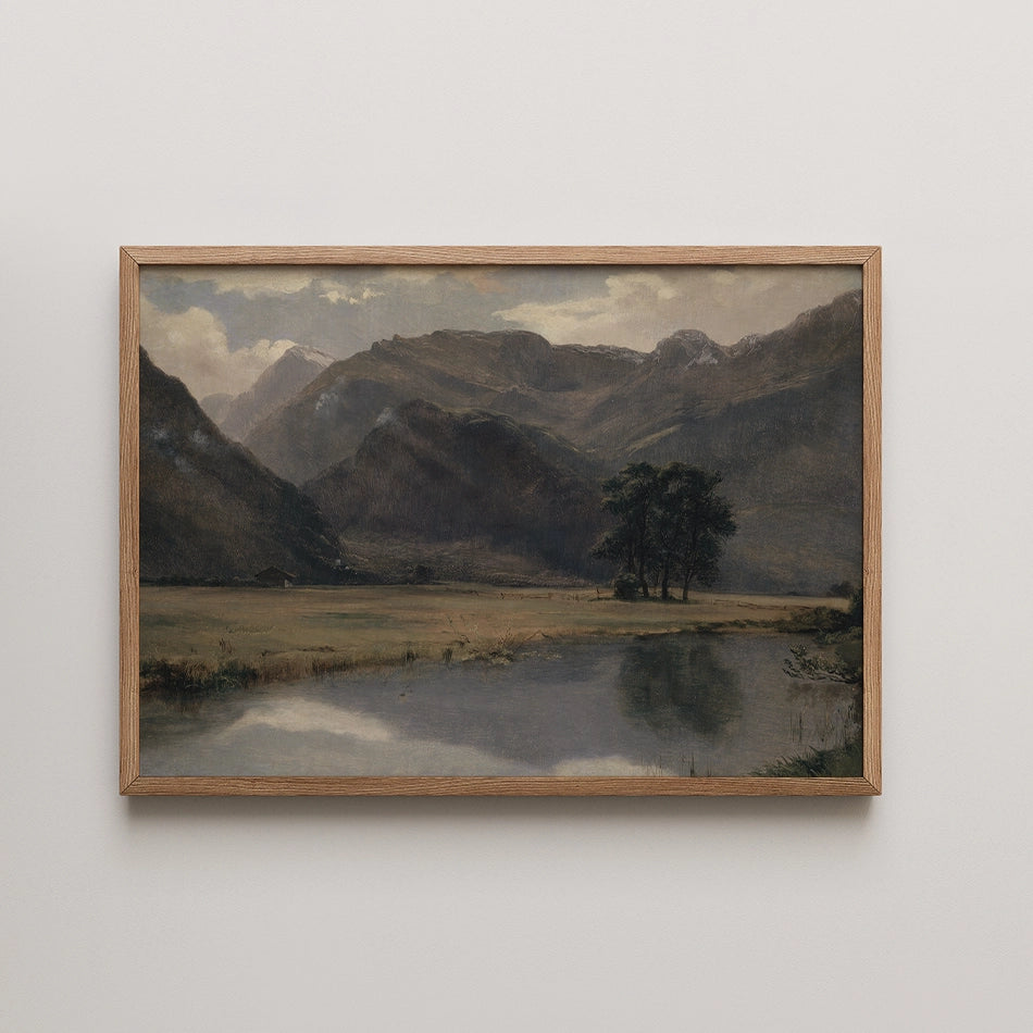 Landscape painting of mountains with a river and trees, framed in natural wood.