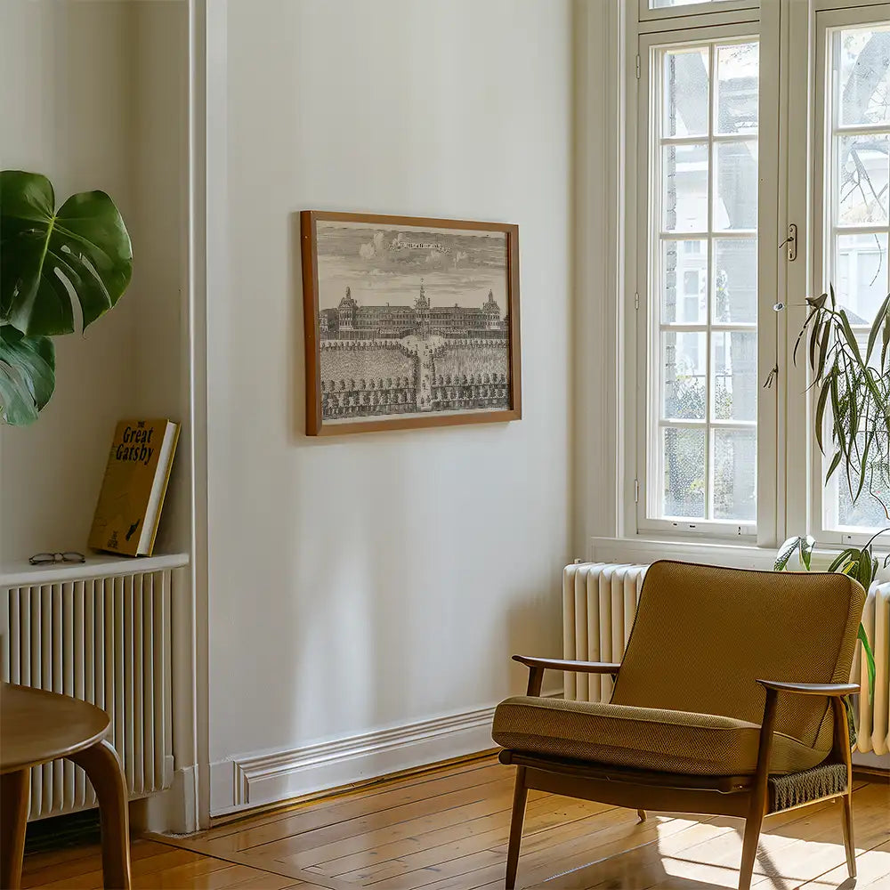 Painting framed on a wall in a cozy room with a chair and houseplant, featuring a classic architectural scene.