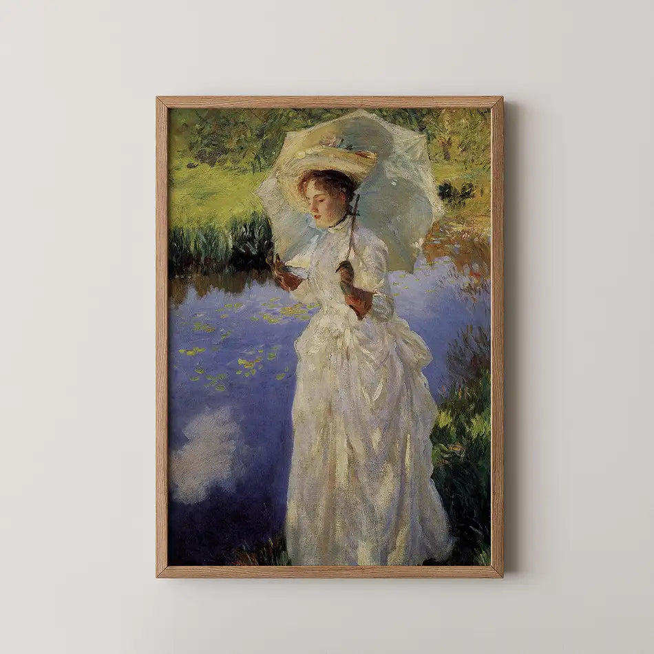 Painting of a woman in a white dress holding a parasol, standing by a pond surrounded by greenery, framed in wood.