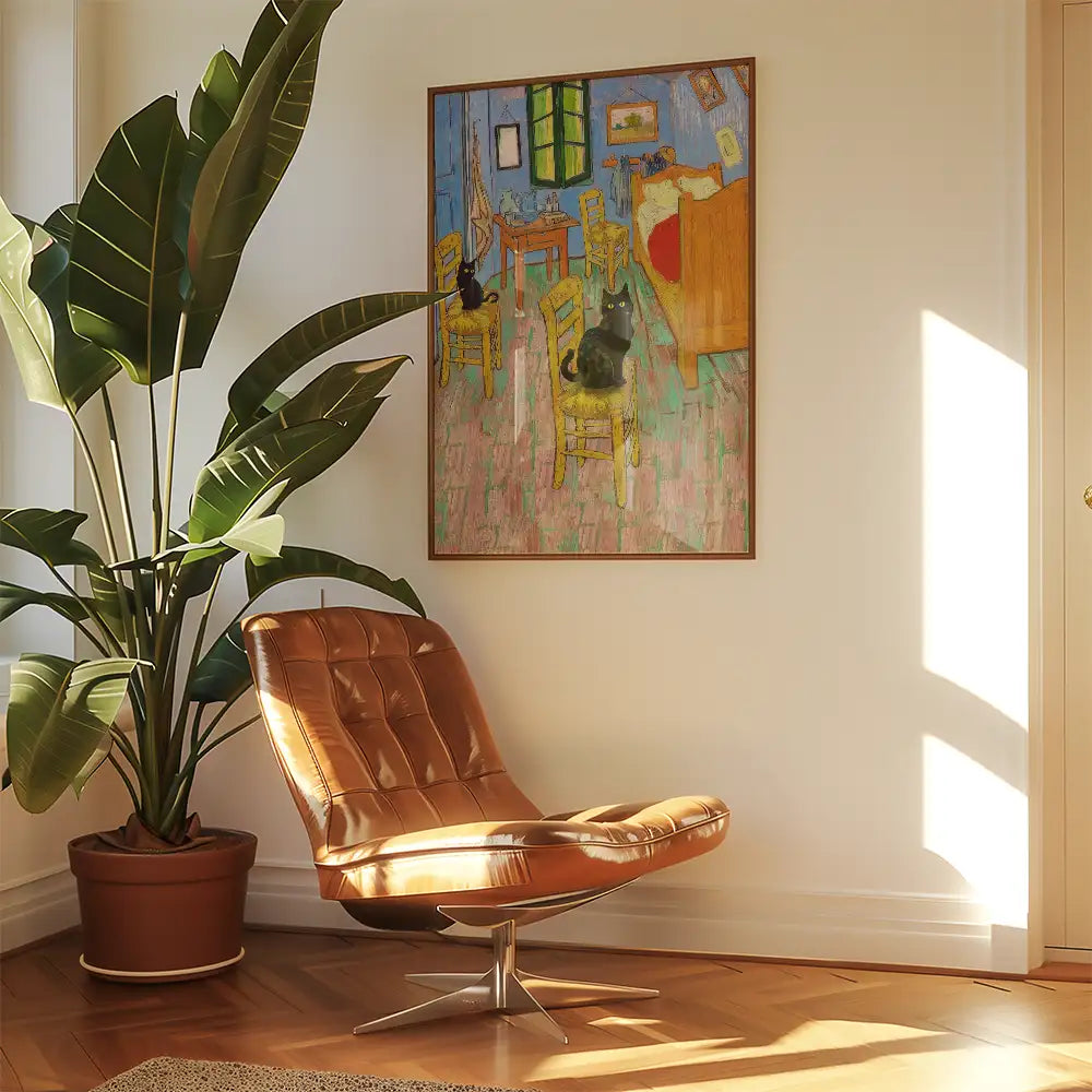 Painting of a colorful interior scene with chairs and a bed, featuring two black cats, hung above a modern brown chair and a leafy plant in a bright room.