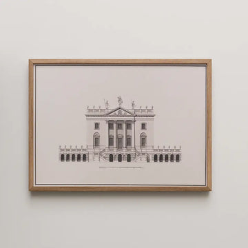 Framed architectural illustration of a historic building with detailed line work, displayed against a white wall.