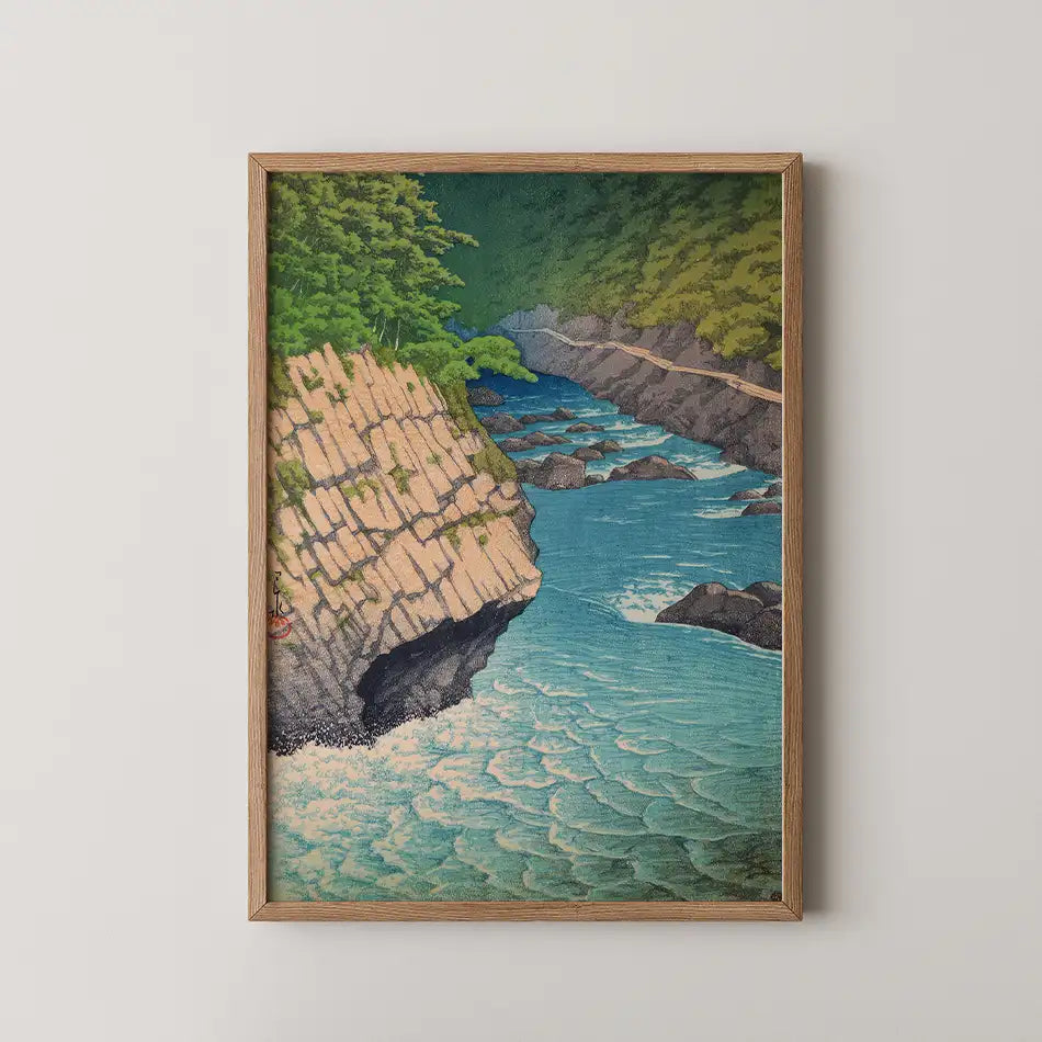 Landscape painting featuring a serene river flowing through rocky cliffs, surrounded by lush green trees, framed in natural wood.