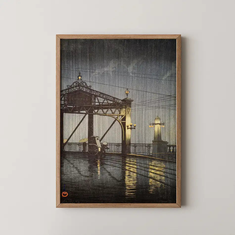Framed painting of a bridge at night with rain, reflecting light from street lamps on a wet surface.
