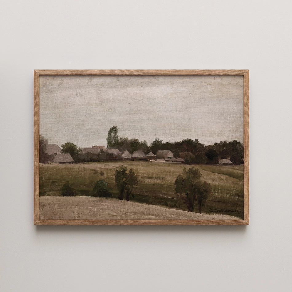 Landscape painting of a rural scene with a cloudy sky and distant houses, framed in light wood.