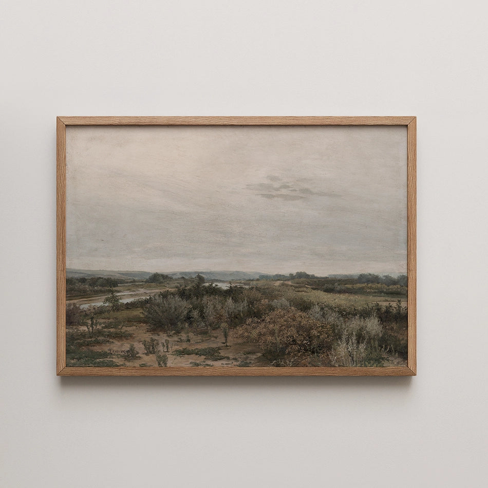 Framed landscape painting featuring a serene view of rolling hills, a river, and lush vegetation under a cloudy sky.