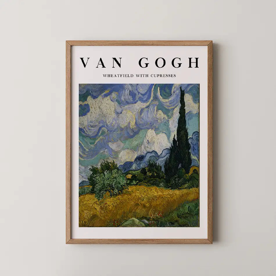 Van Gogh poster featuring "Wheatfield with Cypresses" in a wooden frame against a light wall.
