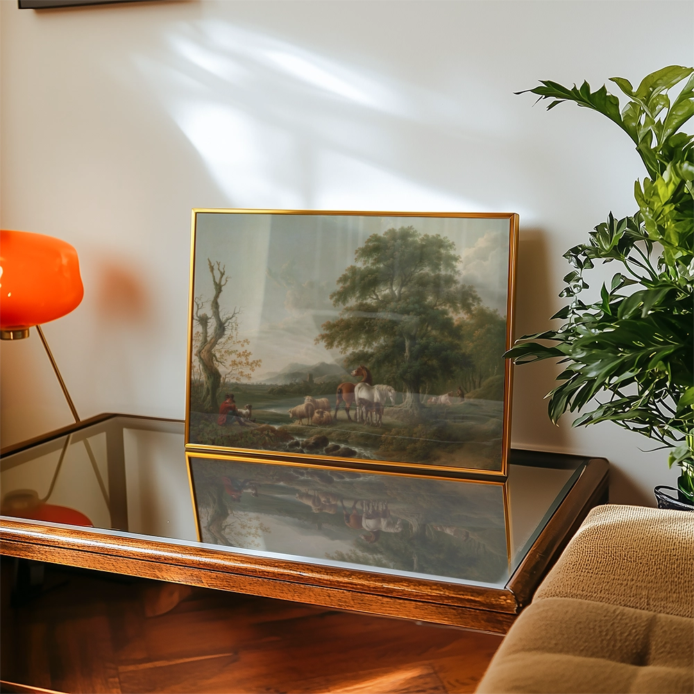 Painting of a serene landscape featuring horses and a figure by a river, displayed in a gold frame on a coffee table with a reflective surface, accompanied by a plant and an orange lamp.