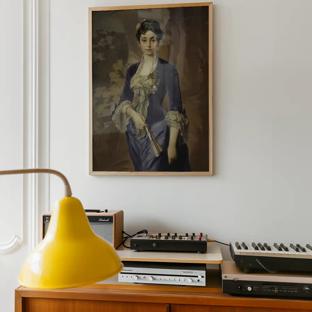 Portrait of a woman in a blue gown holding a small object, framed and hanging on a wall next to a yellow lamp and vintage audio equipment.