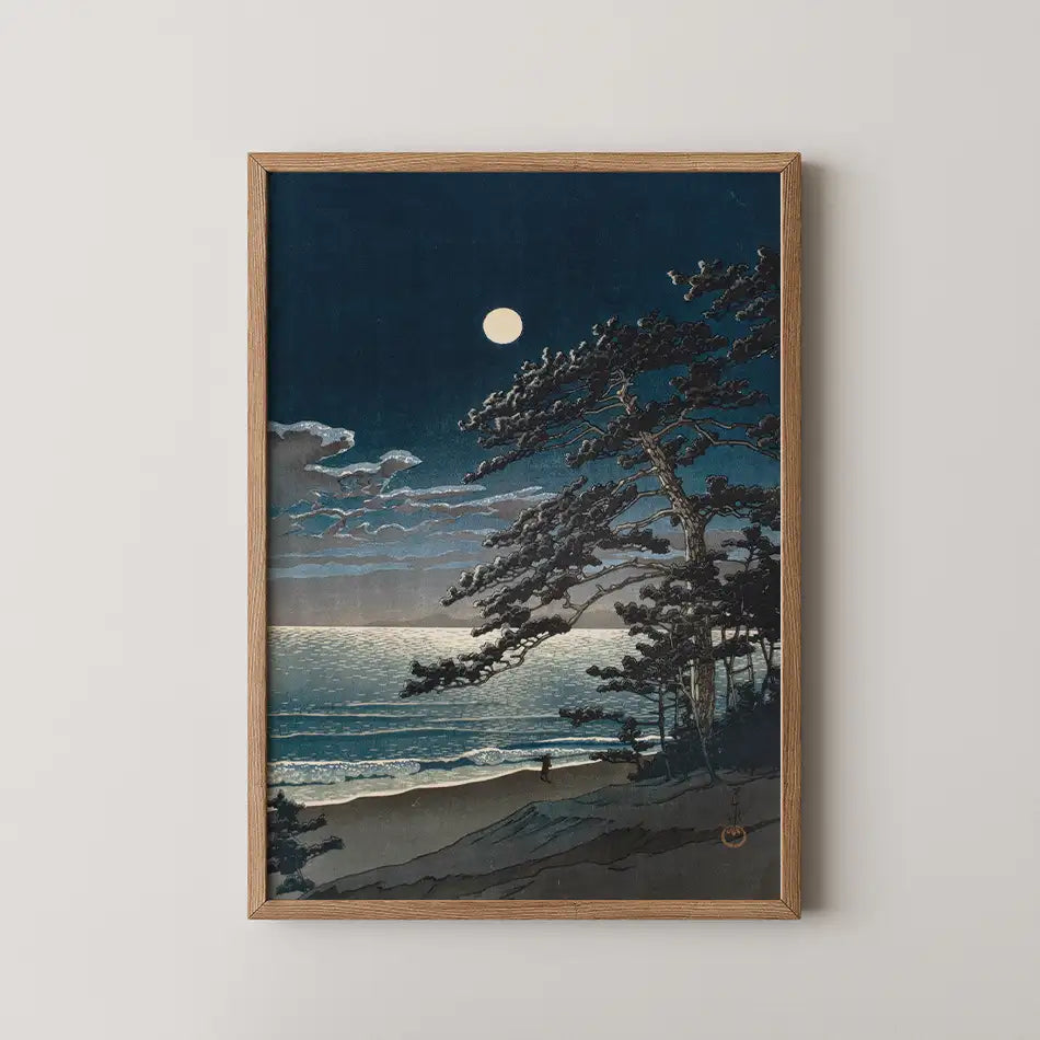 Framed painting of a moonlit beach scene with trees and waves under a dark sky.