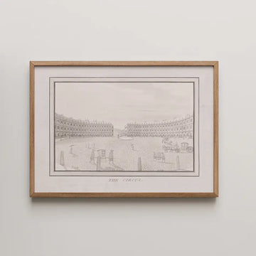 Framed black and white illustration of a historic circus with buildings and people, titled "The Circus"