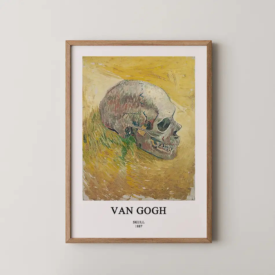 Framed painting of a human skull by Van Gogh, titled "Skull," created in 1887, displayed against a yellow background.