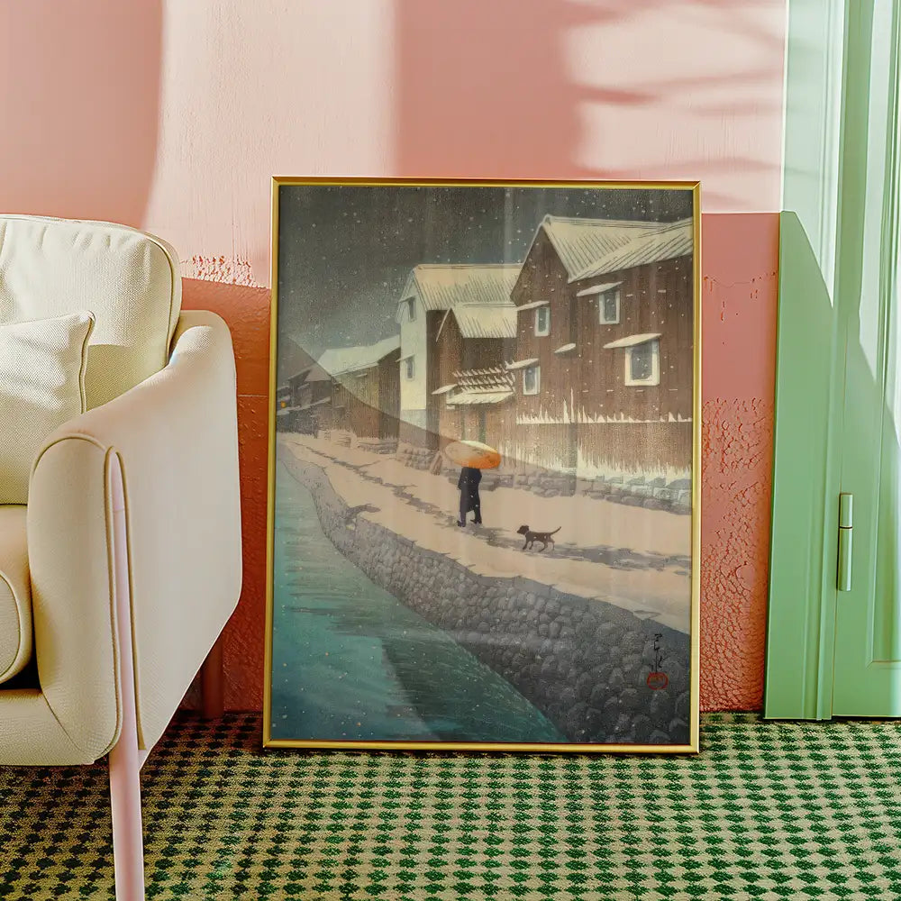 Framed painting of a snowy landscape featuring a person with an umbrella walking a dog along a riverbank, set against a background of wooden houses.