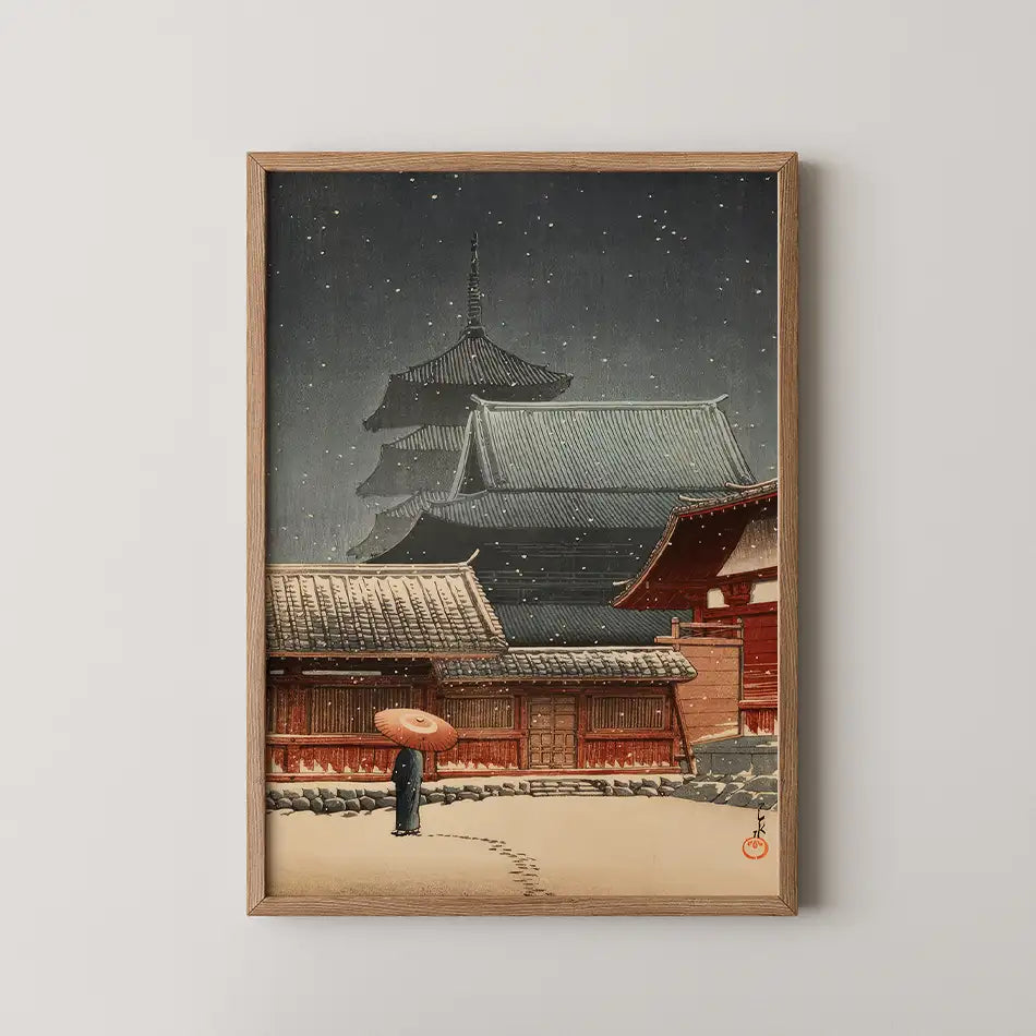 Traditional Japanese painting featuring a figure with an umbrella in a snowy landscape, framed in wood.