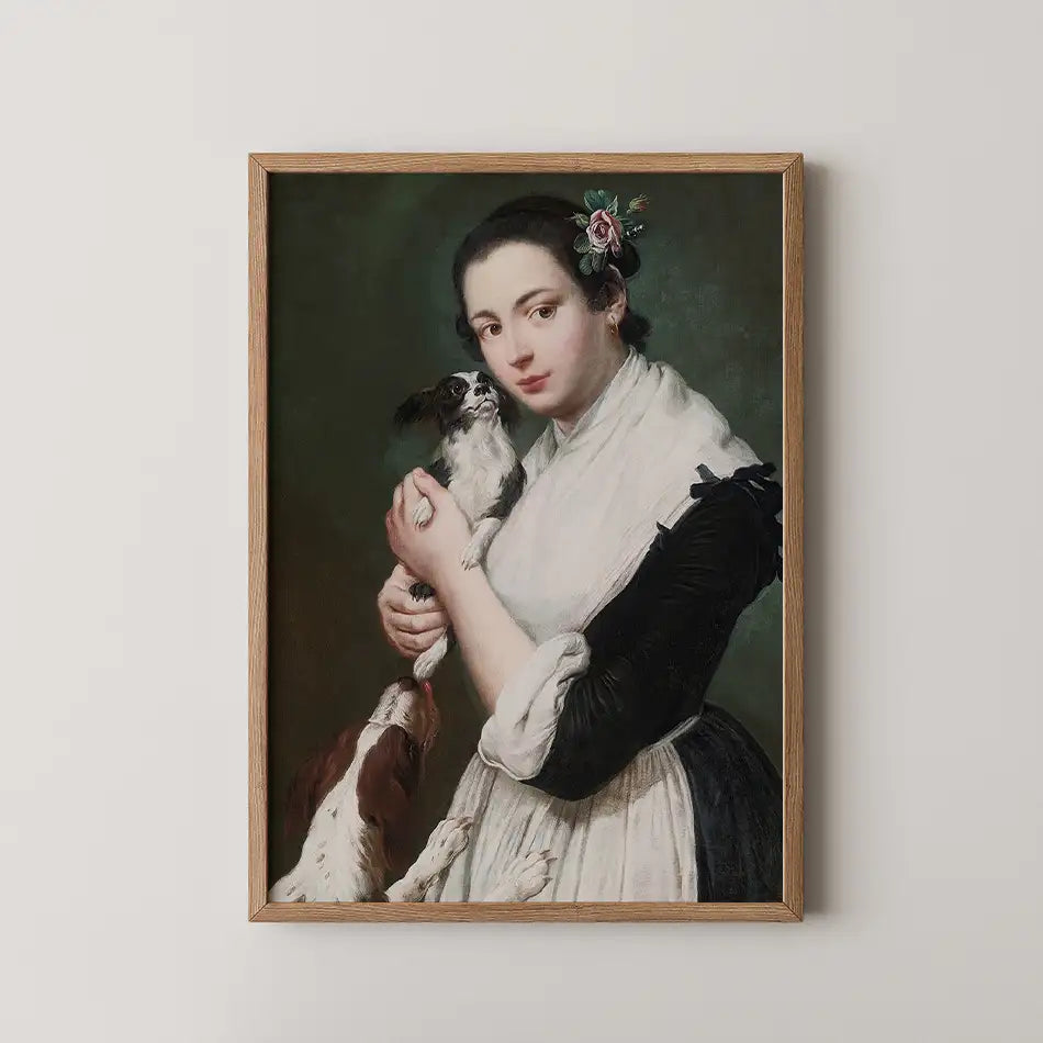 Portrait of a young woman with dark hair holding a small dog, surrounded by two other dogs, in a framed painting.