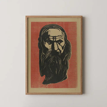 Black and white artistic portrait of an elderly man with a long beard, set against a bold red background, framed in wood.