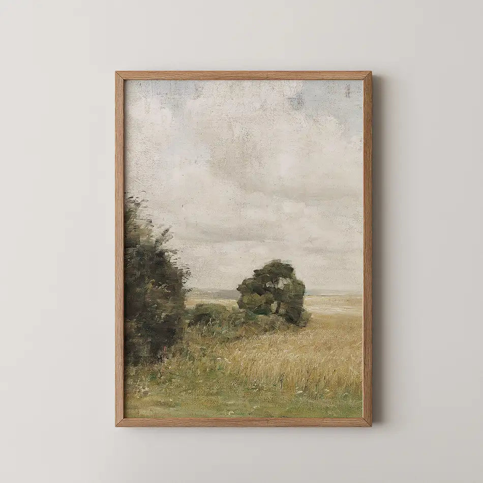 Framed painting of a serene landscape featuring grassy fields and gentle trees under a cloudy sky.