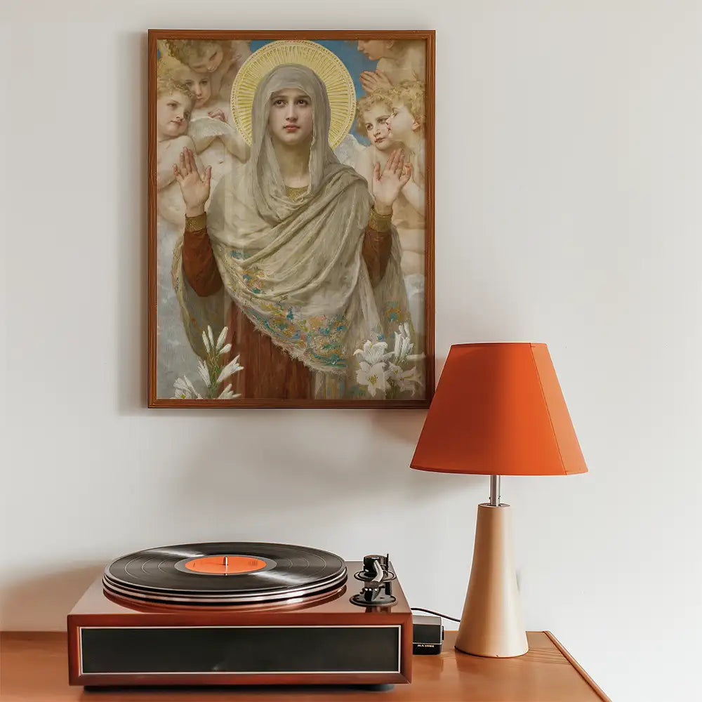 Painting of a serene woman in a headscarf surrounded by angels, framed and displayed on a wall above a wooden turntable and an orange lamp.