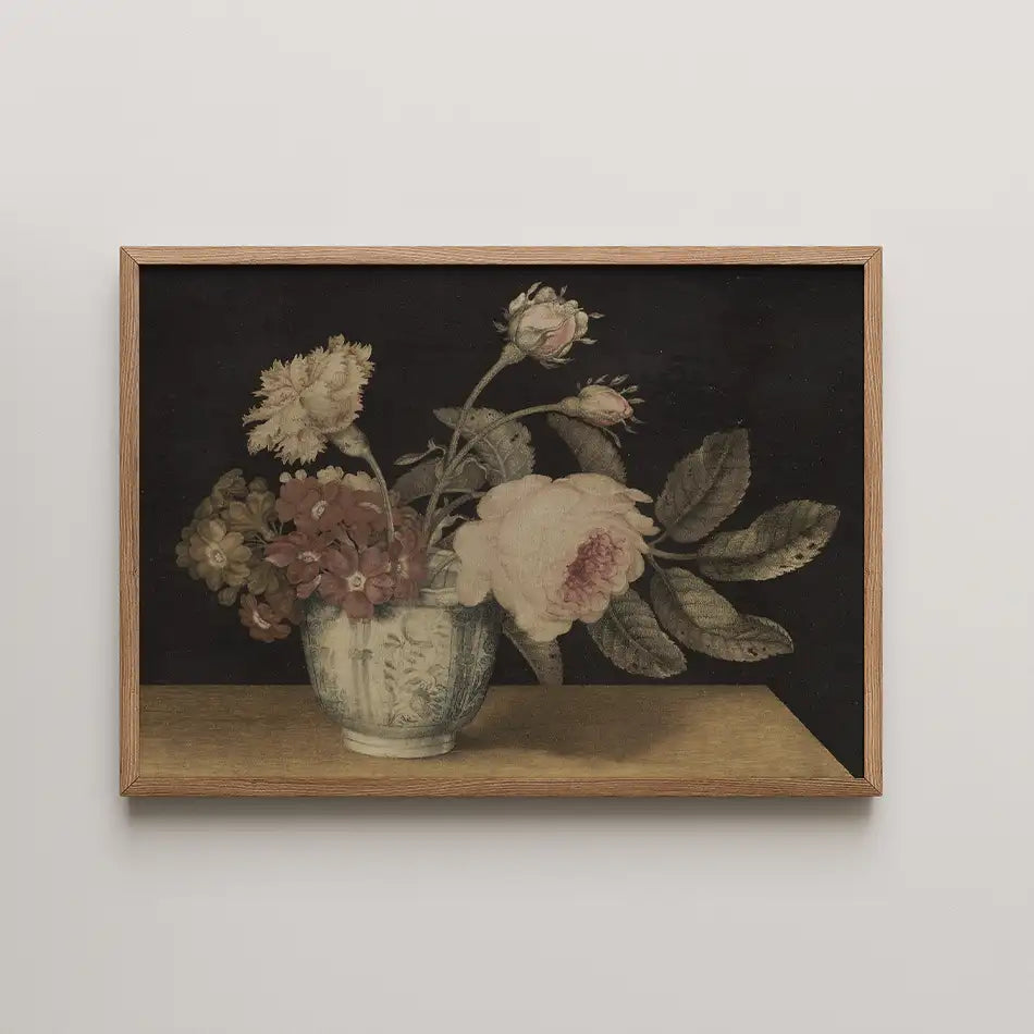 Painting of a flower arrangement in a blue and white vase on a wooden table, framed in natural wood.