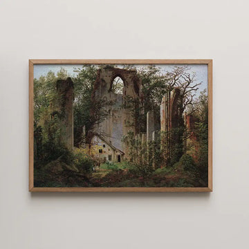 Painting of an old, overgrown ruin surrounded by trees, with a small house visible in the foreground, framed in light wood.
