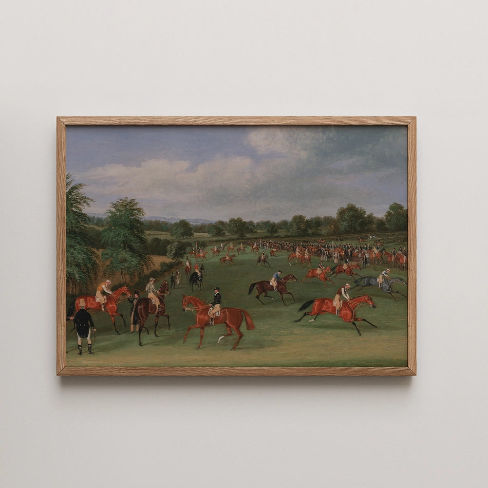 Historical painting of a horse racing scene with multiple riders and spectators in a green landscape, framed in wood.