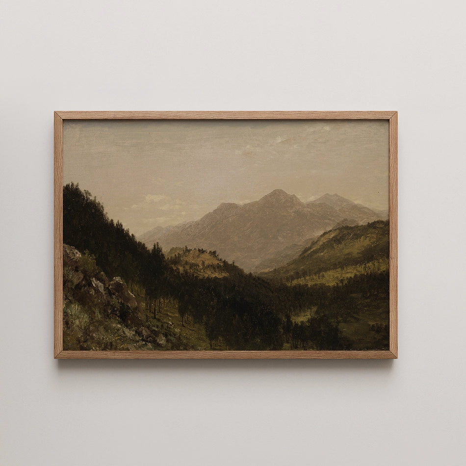 Framed landscape painting featuring rolling mountains and lush greenery under a cloudy sky.