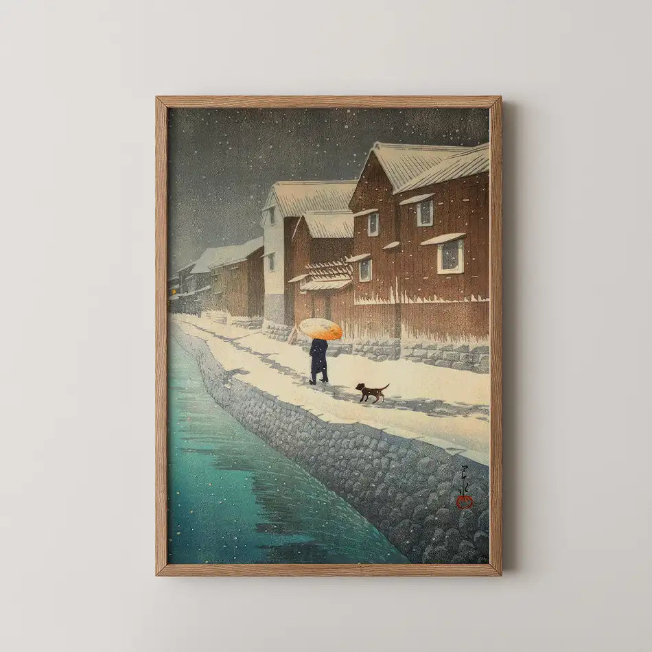 A serene winter scene painting featuring a figure walking with a dog along a snowy riverside path, surrounded by quaint wooden houses under falling snow, framed in natural wood.