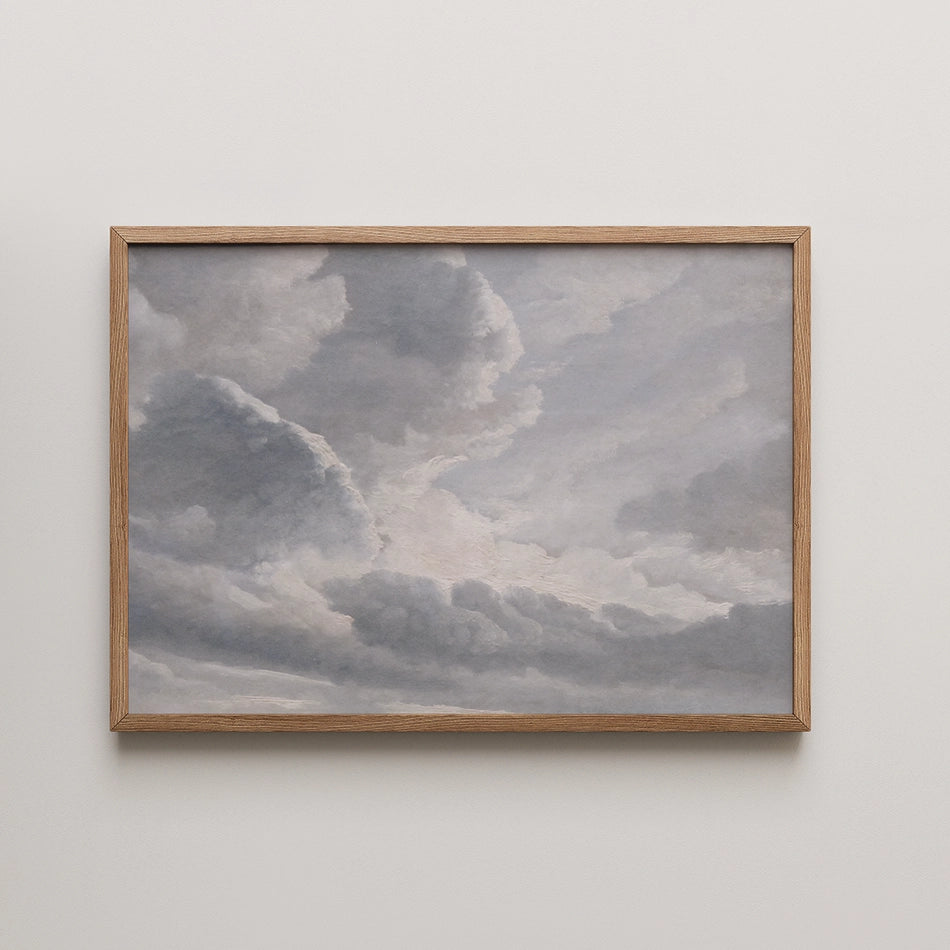 Painting of a cloudy sky in soft gray tones, framed in light wood.