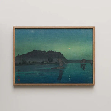 Framed painting of a serene night scene featuring a crescent moon, calm waters, and traditional sailboats against a greenish-blue sky.