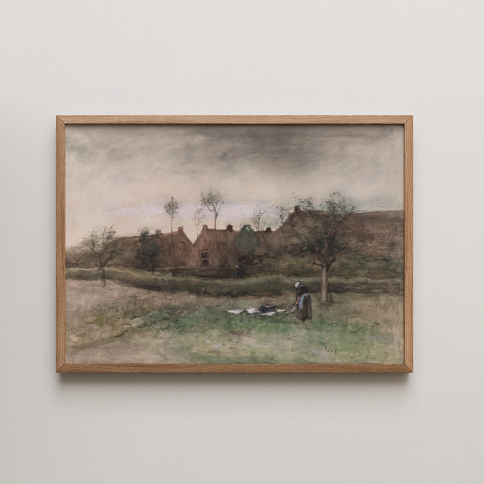 Watercolor painting of a rural landscape with a woman tending to the ground in front of a rustic house, framed in natural wood.