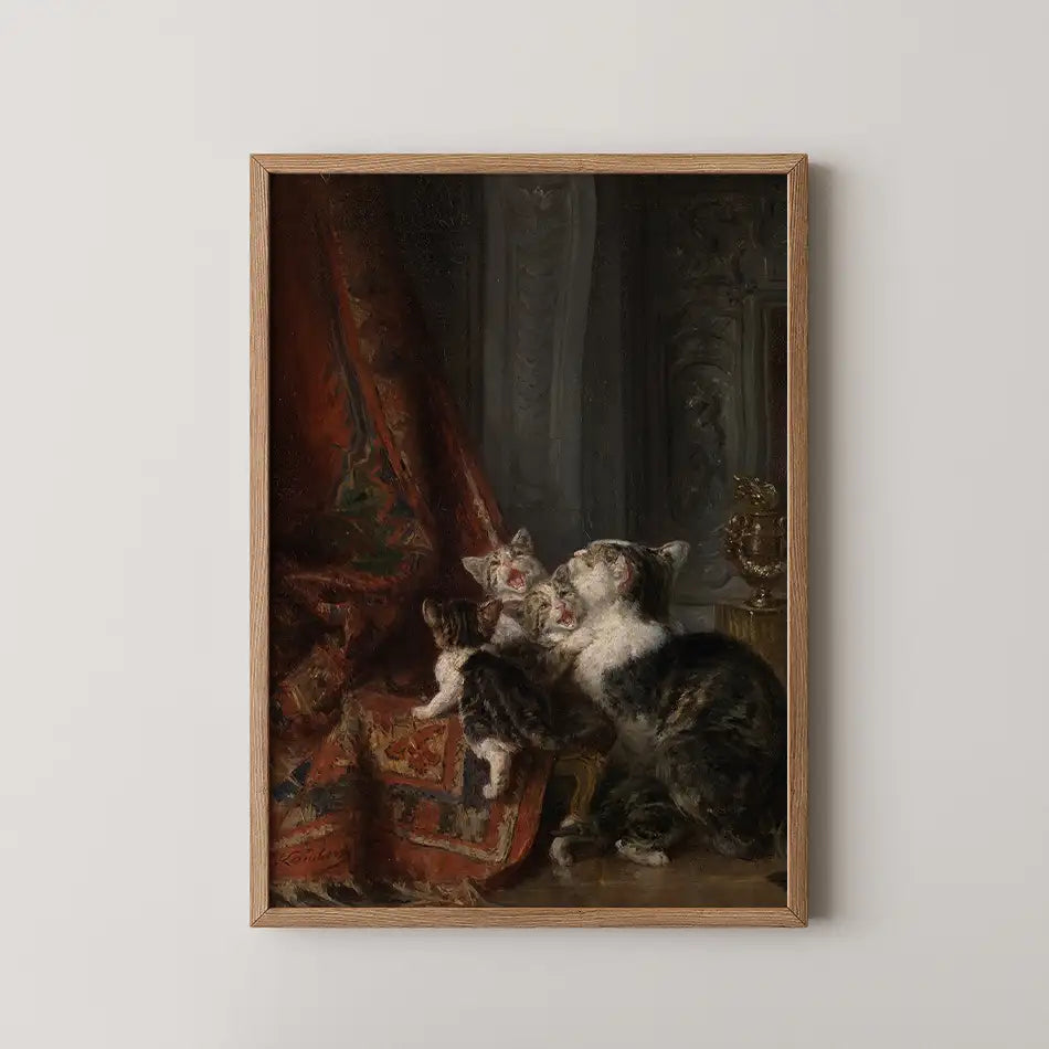Painting of three kittens next to a red draped fabric, framed in wood.