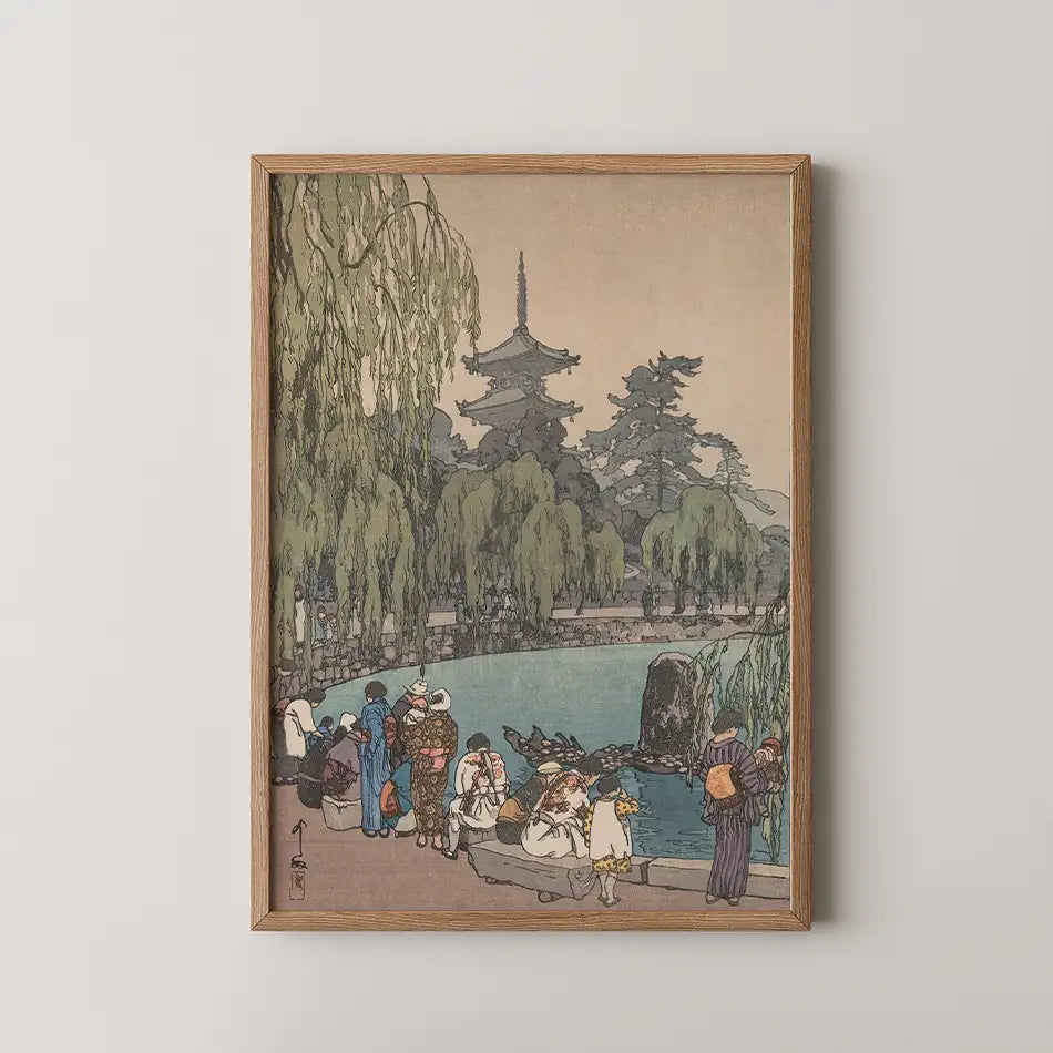 Framed painting depicting a serene landscape with a pond, willow trees, and figures in traditional clothing near a pagoda.