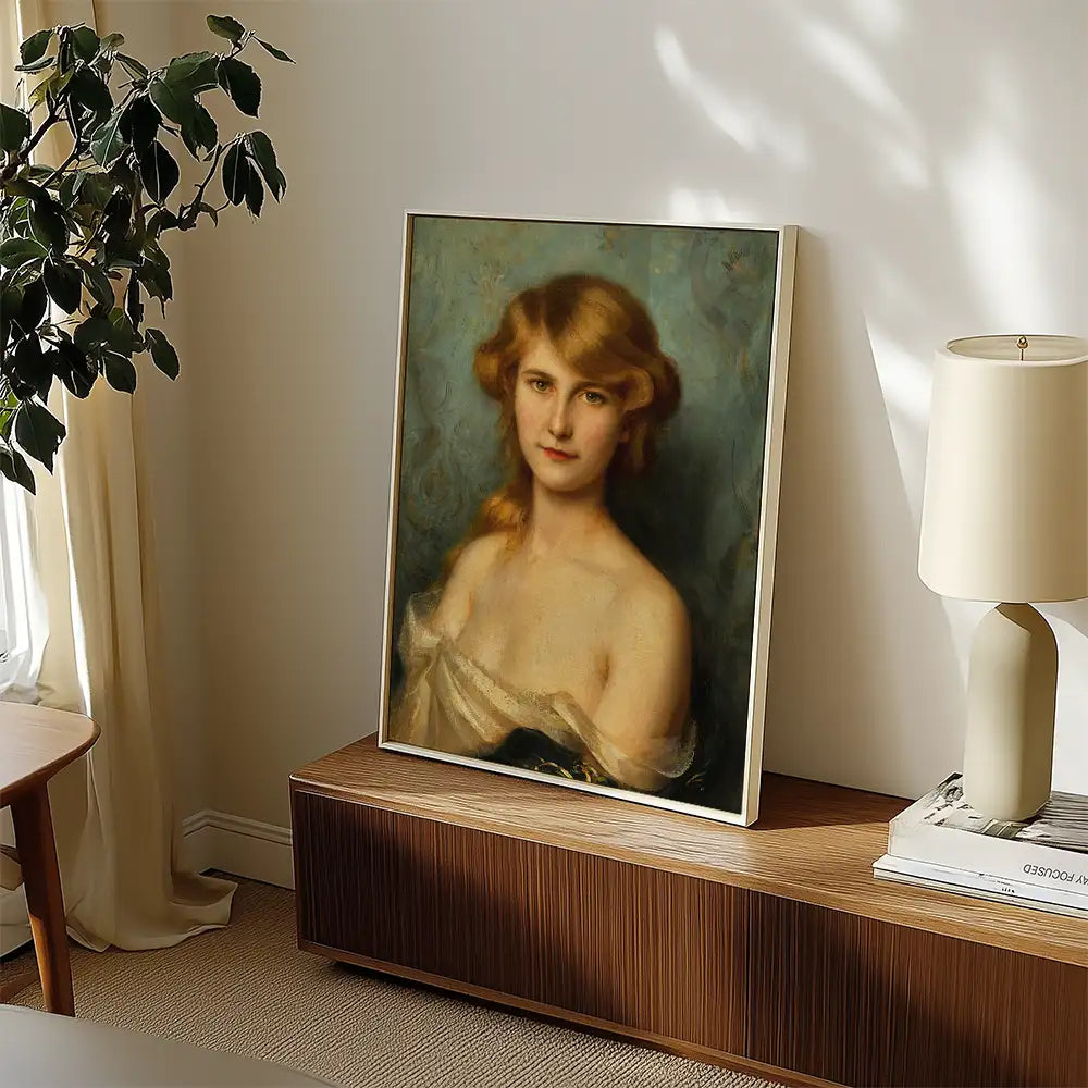 Portrait painting of a young woman with blonde hair, displayed in a framed setting beside a lamp and a decorative plant.